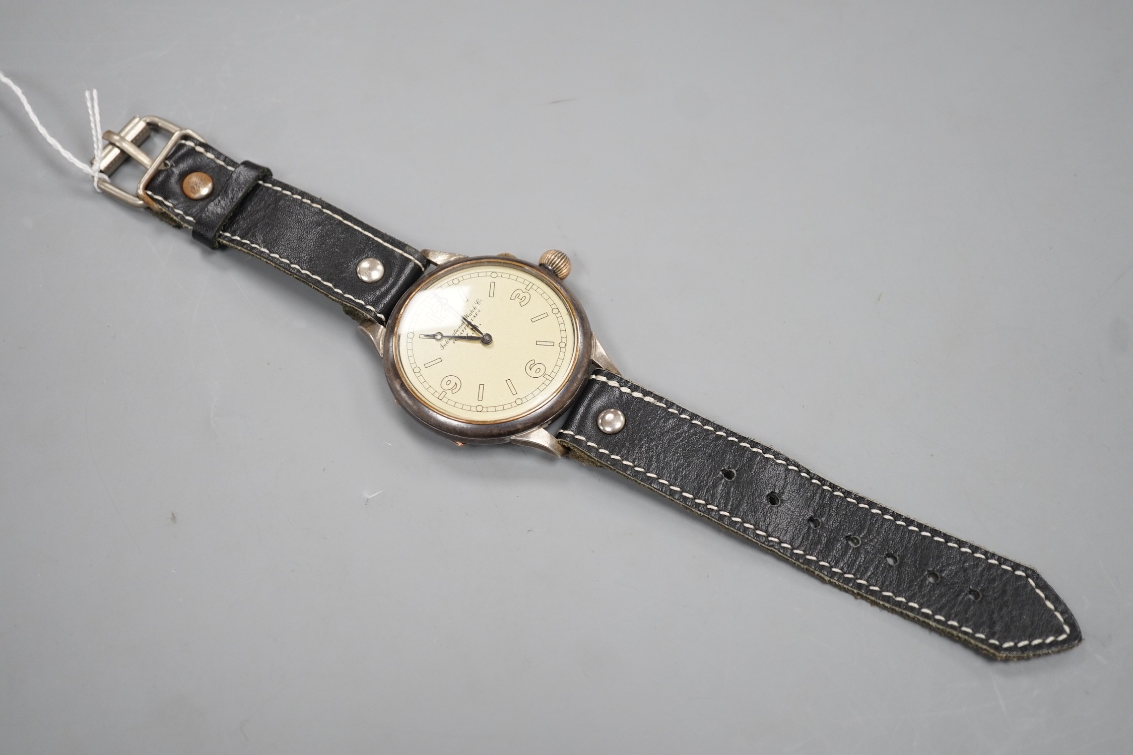 A Kriegsmarine style gun metal manual wind wrist watch, converted from a pocket watch, with later adapted dial, on a leather strap